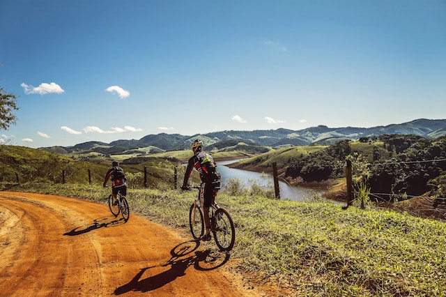 Bicyclist passing the road near the river